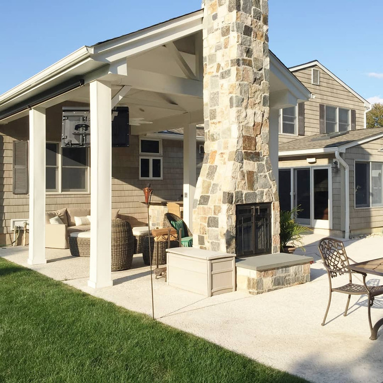 Covered patio pavilion with stone fireplace and seating area