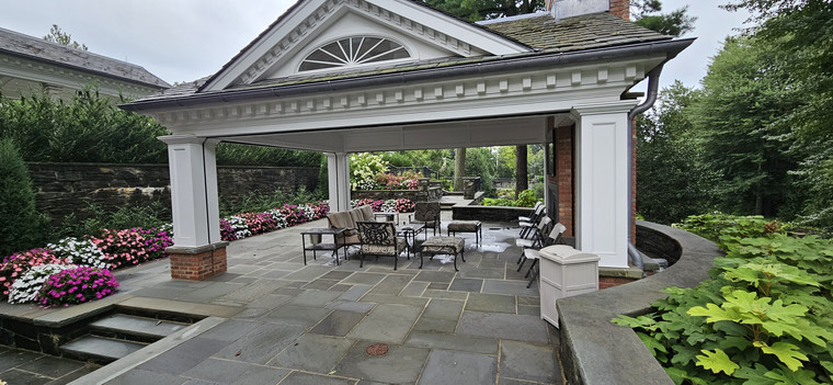 Classical pavilion with bluestone terrace and surrounding garden walls