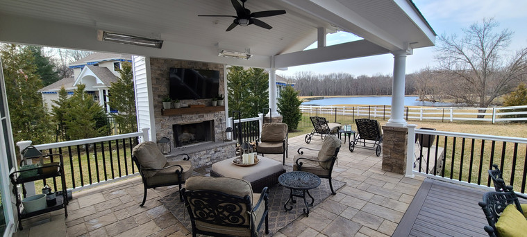 Covered deck pavilion with fireplace and lounge seating