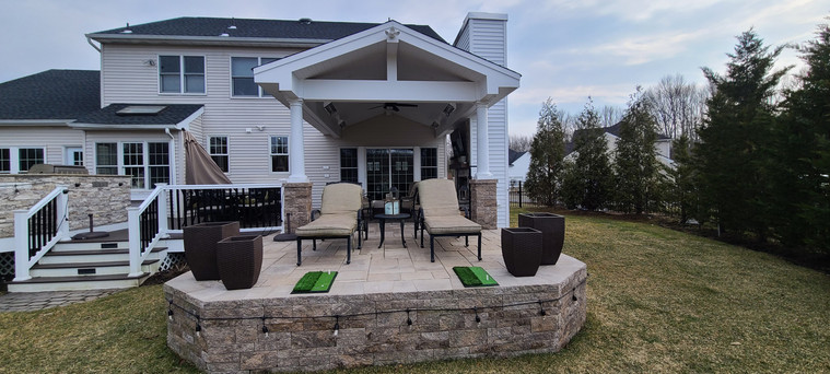 Raised pavilion terrace built over a retaining wall with lounge seating